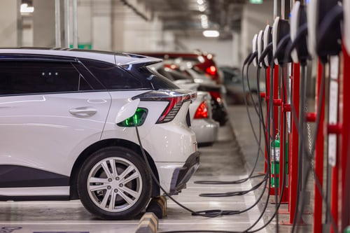 Photo of electric vehicle at a charging station in a garage